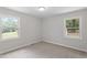 Cozy bedroom with two windows providing ample natural light and carpeted flooring at 2702 Red Valley Dr, Rougemont, NC 27572