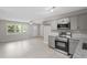 Open kitchen and living area with stainless steel appliances and ample natural light at 2702 Red Valley Dr, Rougemont, NC 27572