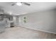 Open-concept living room features a ceiling fan, stainless steel appliances, and modern gray cabinets at 2702 Red Valley Dr, Rougemont, NC 27572