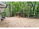 Secluded backyard features a wooden gazebo with manicured landscaping and mature trees at 2905 Scuppernong Ln, Durham, NC 27703