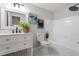 Clean bathroom with a white vanity, framed mirror, tub/shower combo, and marble tile at 2905 Scuppernong Ln, Durham, NC 27703