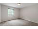 Bright bedroom features neutral walls, carpet floors, and a window that overlooks a wooded area at 2905 Scuppernong Ln, Durham, NC 27703