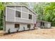 Stylish home featuring gray siding, new landscaping, a red door, and modern window design at 2905 Scuppernong Ln, Durham, NC 27703