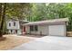 Charming split-level home with gray siding, red front door, and well-maintained landscaping at 2905 Scuppernong Ln, Durham, NC 27703