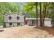 Charming split-level home with gray siding, brick accents, and a vibrant red front door at 2905 Scuppernong Ln, Durham, NC 27703