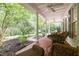Inviting porch features brick flooring, ceiling fans, wicker furniture, and trees at 300 Oak Ridge Dr, Hillsborough, NC 27278