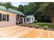 Backyard featuring a hot tub, deck, and mature trees at 300 Oak Ridge Dr, Hillsborough, NC 27278