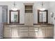 Bright bathroom featuring dual sinks, granite countertops, a central cabinet, and decorative lighting at 300 Oak Ridge Dr, Hillsborough, NC 27278