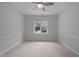 Cozy bedroom features carpet, a ceiling fan, and a bright window at 300 Oak Ridge Dr, Hillsborough, NC 27278