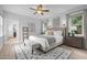 Comfortable bedroom featuring hardwood floors, a ceiling fan, and natural light at 300 Oak Ridge Dr, Hillsborough, NC 27278