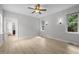 Bright bedroom featuring hardwood floors, a ceiling fan, and sconce lighting at 300 Oak Ridge Dr, Hillsborough, NC 27278