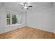A bright and airy bedroom featuring hardwood floors and a large bay window with natural light at 300 Oak Ridge Dr, Hillsborough, NC 27278