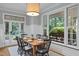 Bright dining room featuring a square table, decorous light fixture, and view of the exterior through a window at 300 Oak Ridge Dr, Hillsborough, NC 27278