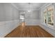 Neutral dining room with wainscotting, wood floors, and a modern light fixture at 300 Oak Ridge Dr, Hillsborough, NC 27278