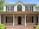 Charming home showcasing the covered front porch with columns and a brick floor entrance at 300 Oak Ridge Dr, Hillsborough, NC 27278