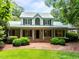 Charming two-story home with a welcoming front porch and lush landscaping at 300 Oak Ridge Dr, Hillsborough, NC 27278