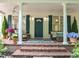 Inviting front porch with brick steps, outdoor seating, and elegant decor at 300 Oak Ridge Dr, Hillsborough, NC 27278