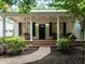 Charming front porch of home featuring ceiling fans, columns, and brick walkway at 300 Oak Ridge Dr, Hillsborough, NC 27278