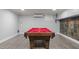 Finished basement game room features a classic pool table with red felt and hardwood flooring at 300 Oak Ridge Dr, Hillsborough, NC 27278