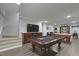Spacious basement featuring game tables, a television, and comfortable seating at 300 Oak Ridge Dr, Hillsborough, NC 27278