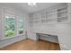 Home office with custom built-ins, a large window overlooking mature trees and ample space for work at 300 Oak Ridge Dr, Hillsborough, NC 27278