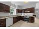Kitchen features dark cabinets, granite countertops, and stainless steel appliances at 300 Oak Ridge Dr, Hillsborough, NC 27278
