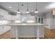 Bright kitchen featuring granite countertops, white cabinets, and a large island at 300 Oak Ridge Dr, Hillsborough, NC 27278