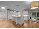 Open kitchen with an island, white cabinetry, granite countertops, stainless appliances, and an exterior view at 300 Oak Ridge Dr, Hillsborough, NC 27278