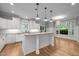 Spacious kitchen with white cabinets, granite countertops, an island and an adjacent dining area at 300 Oak Ridge Dr, Hillsborough, NC 27278
