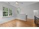 Open-concept living room with hardwood floors and abundant natural light from large windows at 300 Oak Ridge Dr, Hillsborough, NC 27278