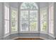 Main bedroom window nook with plantation shutters provides ample sunlight and views of the mature trees at 300 Oak Ridge Dr, Hillsborough, NC 27278