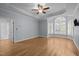 Spacious main bedroom features a tray ceiling, hardwood floors, and a window nook with natural light at 300 Oak Ridge Dr, Hillsborough, NC 27278