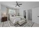 Comfortable main bedroom featuring a ceiling fan and a cozy bed on a decorative rug at 300 Oak Ridge Dr, Hillsborough, NC 27278