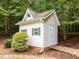 Charming outbuilding with board and batten siding, green shutters, and a decorative weather vane adding character at 300 Oak Ridge Dr, Hillsborough, NC 27278