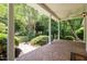 Spacious covered porch with brick flooring and views of the lush greenery at 300 Oak Ridge Dr, Hillsborough, NC 27278