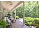 Inviting covered porch with comfortable seating and a cozy fire table at 300 Oak Ridge Dr, Hillsborough, NC 27278