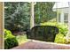 Cozy porch with a hanging swing, brick flooring, and views of the landscaped yard at 300 Oak Ridge Dr, Hillsborough, NC 27278