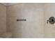 Close-up of shower with beige tile and a metal shower head at 300 Oak Ridge Dr, Hillsborough, NC 27278