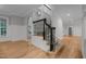 Traditional staircase with wooden steps, a black iron railing, and an arched doorway at 300 Oak Ridge Dr, Hillsborough, NC 27278