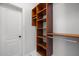 Functional walk-in closet with custom wood shelving and a hanging rod for storage at 300 Oak Ridge Dr, Hillsborough, NC 27278
