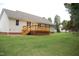 Expansive backyard featuring a wooden deck attached to the home at 3145 Pier Pointe Dr, Creedmoor, NC 27522