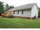 Wide shot of backyard with a wooden deck and brick base at 3145 Pier Pointe Dr, Creedmoor, NC 27522