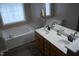 Bathroom with double sink vanity, soaking tub, and tiled window at 3145 Pier Pointe Dr, Creedmoor, NC 27522