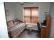 Bright bedroom with bed, desk, and window with blinds at 3145 Pier Pointe Dr, Creedmoor, NC 27522
