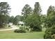 Picturesque view of a quiet community street lined with mature trees and well-kept lawns at 3145 Pier Pointe Dr, Creedmoor, NC 27522