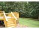 Wooden deck with steps down to a green lawn at 3145 Pier Pointe Dr, Creedmoor, NC 27522