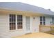 Exterior home view featuring a wooden deck, white siding and lots of windows at 3145 Pier Pointe Dr, Creedmoor, NC 27522