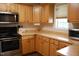 Charming kitchen featuring stainless steel appliances, light wood cabinets, and laminate countertops at 3145 Pier Pointe Dr, Creedmoor, NC 27522