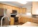 Bright kitchen with stainless steel appliances, light wood cabinets, and ample counter space at 3145 Pier Pointe Dr, Creedmoor, NC 27522