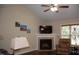 Comfortable living room with a fireplace, ceiling fan, and ample natural light at 3145 Pier Pointe Dr, Creedmoor, NC 27522